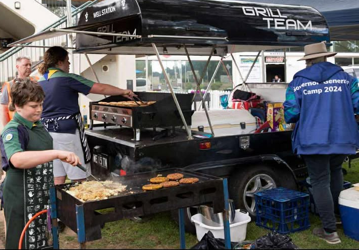 Two members of the Well Station Scout group cooking up a storm on their Grill Team BBQs